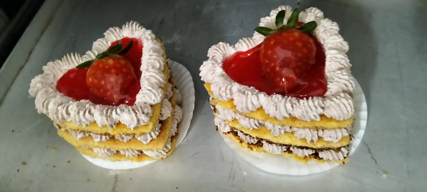 Mini bolos em forma de coração com creme e morango